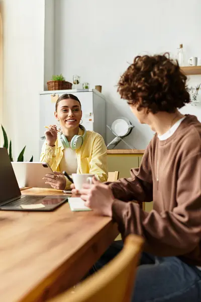 Couple enjoys laughter and coffee at home, creating joyful memories together. — Stock Photo