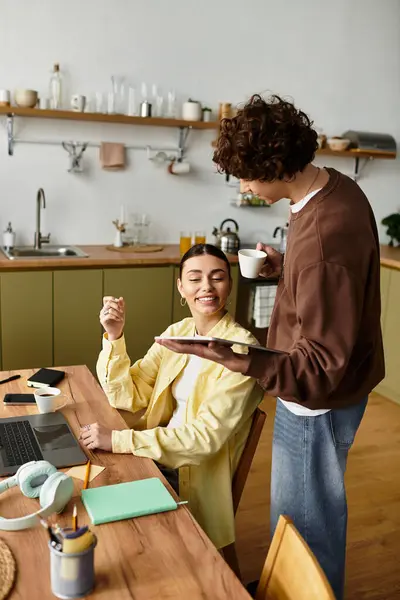 Sweet exchange between a couple in their kitchen as they share smiles and coffee together. — Stock Photo