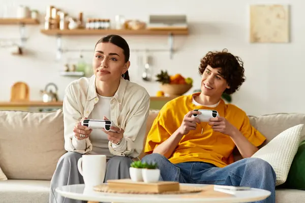 Loving couple shares laughter and excitement while gaming at home on a relaxing evening. — Stock Photo