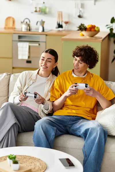 Couple shares laughter and fun while gaming on a comfortable sofa at home. — Stock Photo