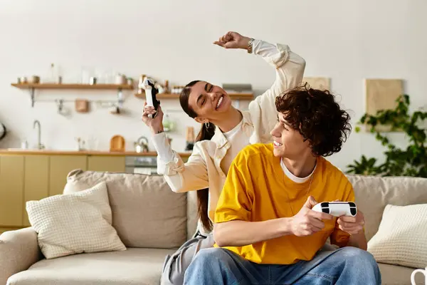 A happy couple plays video games on a comfortable couch, filled with laughter and love at home. — Stock Photo