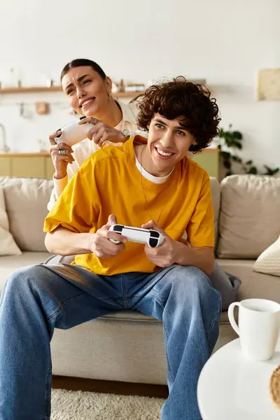 Man and woman share a playful moment while gaming together on a comfortable couch. — Stock Photo