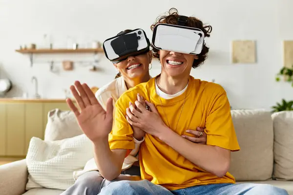 Loving couple experiences a virtual reality game in their cozy living room, filled with laughter. — Stock Photo