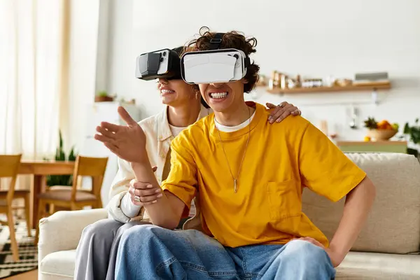 A happy couple enjoys laughter exploring virtual reality in their chic living room. — Stock Photo