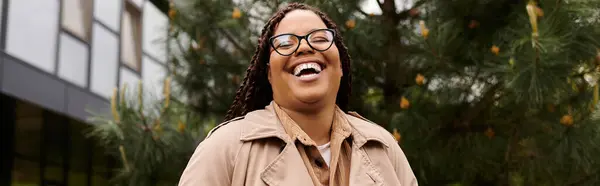 University educator shares a bright smile while surrounded by greenery on campus. — Stock Photo