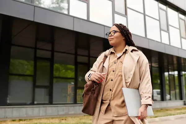 Une femme en tenue professionnelle se promène en toute confiance à l'extérieur de son campus universitaire par une belle journée. — Photo de stock