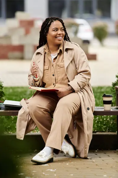 A university teacher smiles and interacts with her students while seated in nature. — Stock Photo
