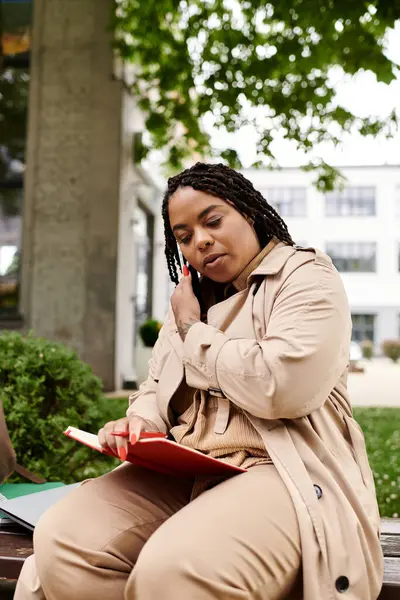 University educator enthusiastically discusses ideas while reading a book outdoors on campus. — Stock Photo