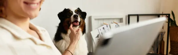 A handsome young man shares a delightful moment with his playful dog in a cozy home setting. — Stock Photo