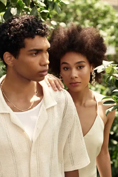 Two young lovers enjoy a serene moment surrounded by vibrant plants in a greenhouse setting. — Stock Photo
