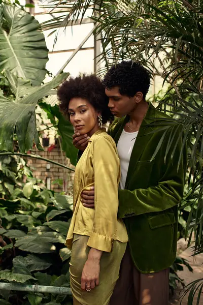 Amidst rich greenery, a young couple embraces, expressing their love and joy for each other. — Stock Photo