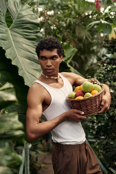 Man enjoys quality time surrounded by thriving plants, sharing smiles and fruits of his labor. — Stock Photo