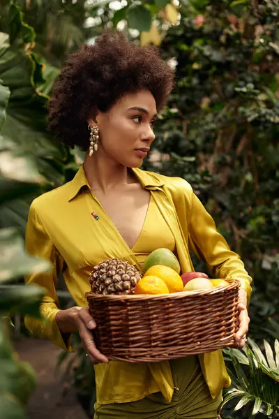 A pretty woman in trendy attire posing amidst thriving plants, showcasing bond and joy. — Stock Photo