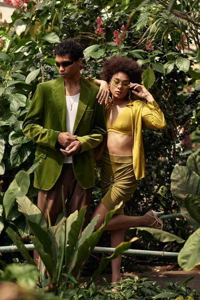 In a tranquil greenhouse, a couple expresses their love while surrounded by flourishing plants. — Stock Photo