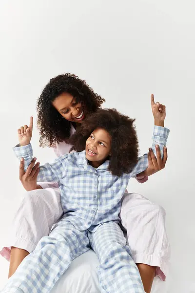 Happy Black mom and daughter in matching PJs laughing together — Stock Photo
