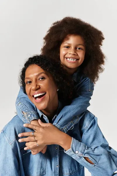 A happy African American Mother and daughter are laughing and hugging in studio — Stock Photo