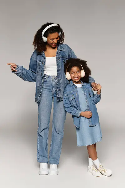 Studio: Black mom and daughter in denim share a happy moment. — Stock Photo