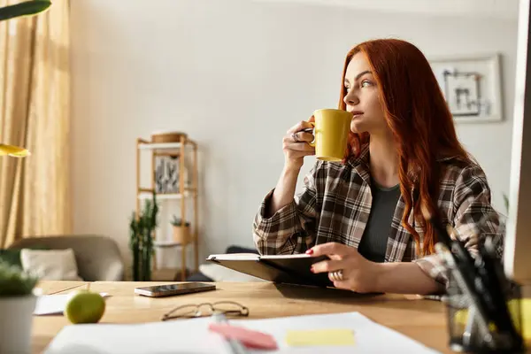 A young beautiful woman relaxes with a cup of tea while reflecting on her day. — Stock Photo