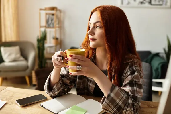 A young beautiful woman savors tea while reflecting in her cozy, sunlit living room. — стоковое фото