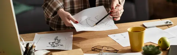 In a cozy space, a young woman sketches her ideas on scattered papers. — Stock Photo