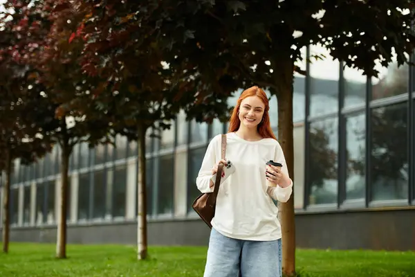 A beautiful young woman relaxes outdoors, sipping coffee while enjoying a warm afternoon. — Stock Photo