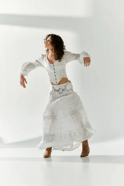 A vibrant young woman expresses her style through dynamic movement in a light filled space. — Stock Photo