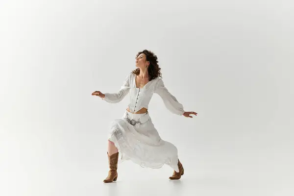 A young woman moves gracefully in a white outfit, showcasing her unique style and confidence. — Stock Photo