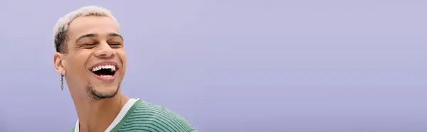 A young man showcases his fashion sense with dyed hair and a trendy outfit, radiating happiness, banner — Stock Photo