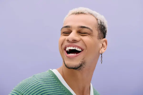 A young african american man with dyed hair smiles confidently while posing fashionably. — Stock Photo