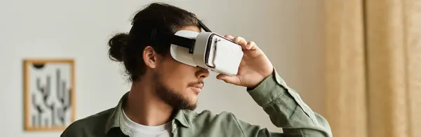 A handsome young man enjoys immersive virtual reality at home, highlighting modern tech. — Stock Photo