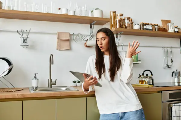 Beautiful woman engaged in a delightful activity at home, surrounded by a warm and inviting kitchen. — Stock Photo