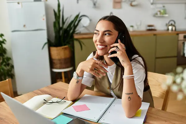 A beautiful young woman relaxes at home, engaged in a friendly phone conversation, smiling. — Stock Photo