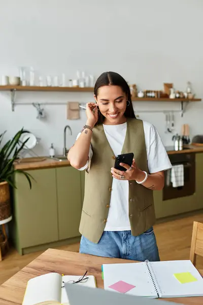 A young woman in casual clothes enjoys a relaxed afternoon at home with her smartphone. — Stock Photo