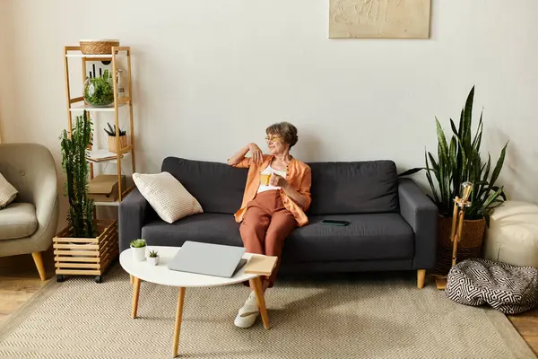 A cozy woman enjoys a warm drink, savoring a peaceful moment at home. — Stock Photo