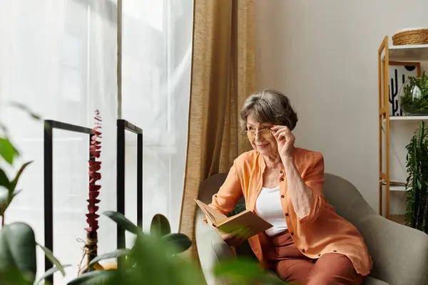 Senior woman immersed in a book, dressed in comfortable clothes, radiating warmth and serenity. — Stock Photo