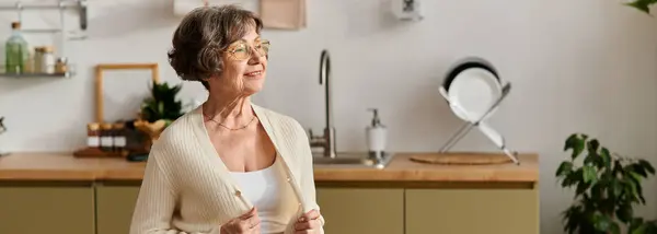 A senior woman enjoys a moment of peace, dressed comfortably in her cozy home setting. — Stock Photo