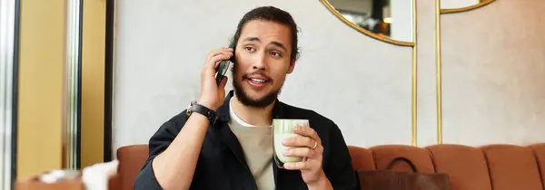 Man engages in a phone conversation while savoring a matcha drink, banner — Stock Photo