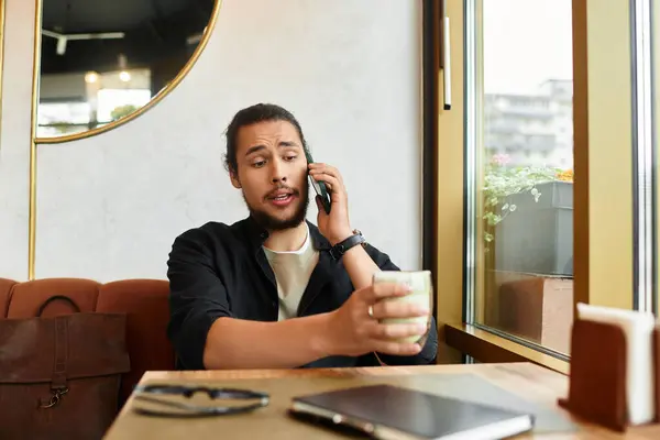 Remote worker engages in a phone call while sipping matcha — Stock Photo