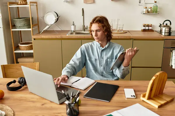 Focused young man showcasing his skills while working on a laptop amidst home comforts. — Stock Photo