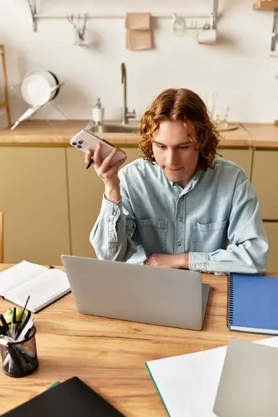 Young man engages in productive work at home, balancing technology and creativity in his space. — Stock Photo