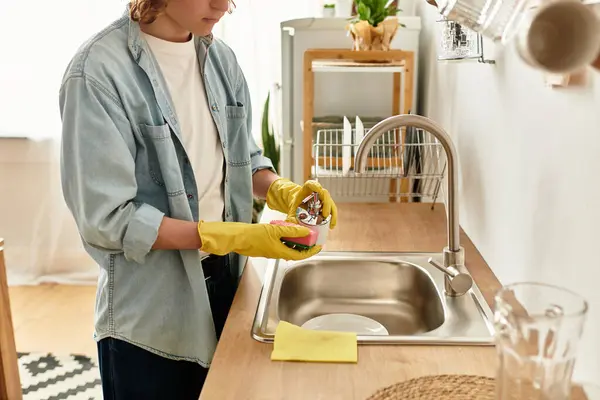 A young man in a comfortable home setting engages in cleaning activities with focus. — Stock Photo