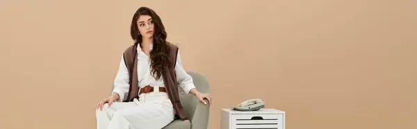 A beautiful young woman with long brown hair models chic fashion in a minimalistic studio, banner — Stock Photo