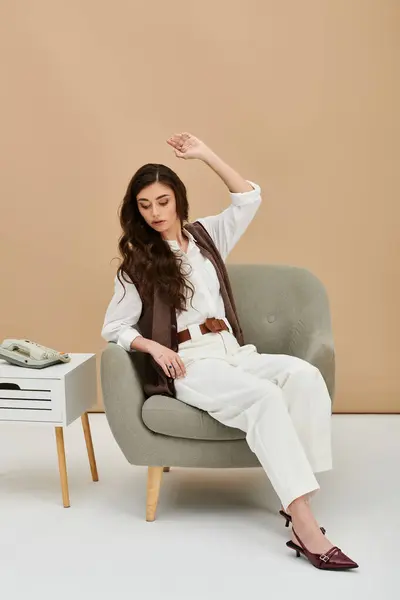 A beautiful young woman poses thoughtfully in a stylish studio, showcasing an elegant outfit. — Stock Photo