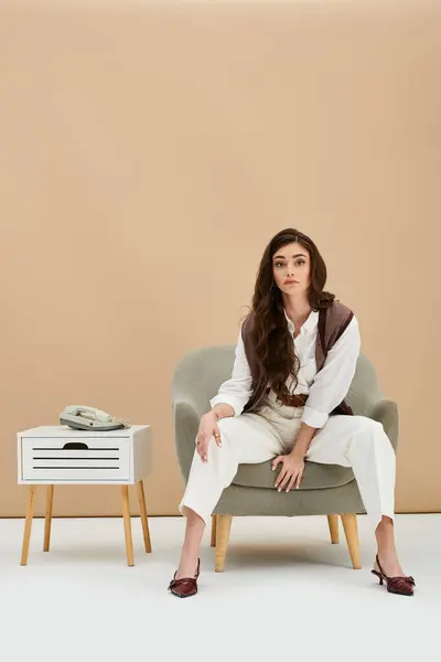 A beautiful young woman with long brown hair showcases her fashion sense in a chic outfit. — Stock Photo