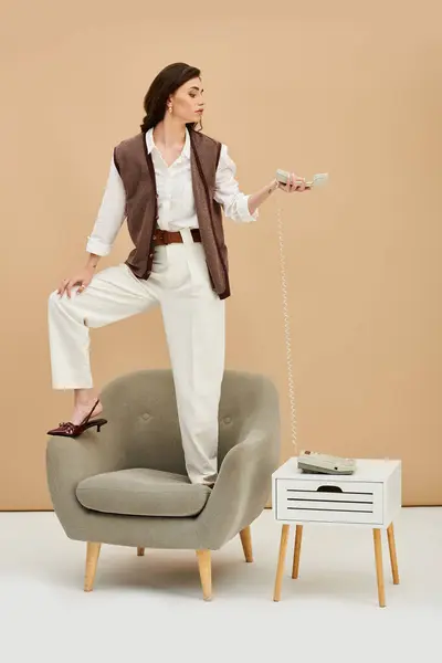 A young woman with long brown hair confidently shows off her stylish outfit. — Stock Photo