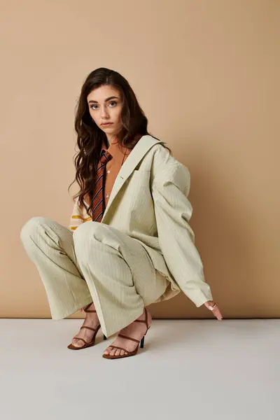 A fashionable young woman showcases her stylish attire and graceful pose in a chic studio. — Stock Photo
