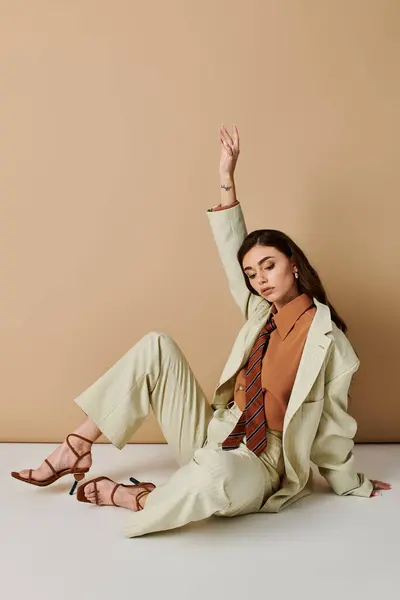 A beautiful young woman shows off a fashionable outfit in a contemporary studio environment. — Stock Photo