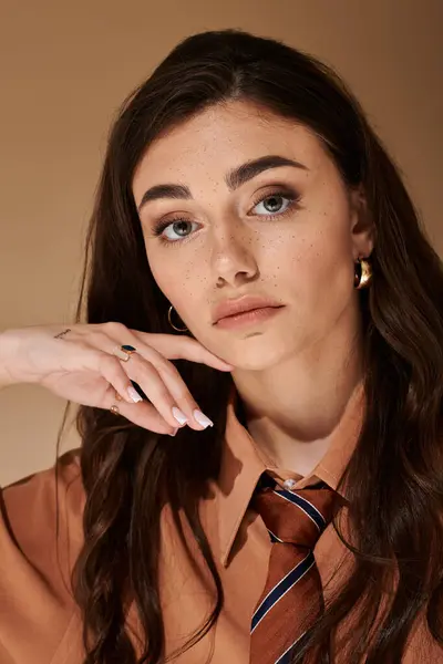 A beautiful young woman showcases her trendy attire and tie while posing in the studio — Stock Photo