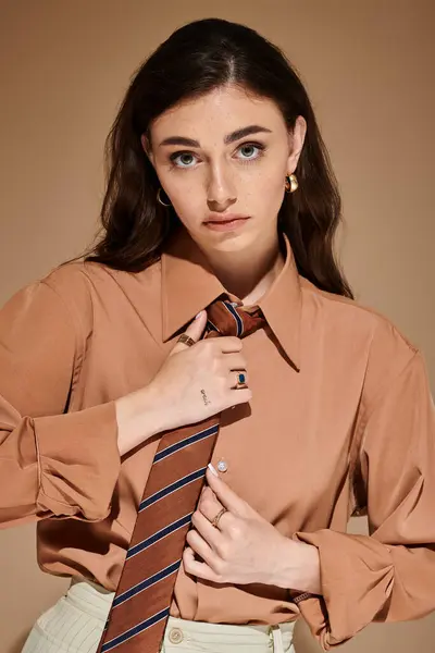 A stylish young woman models a chic attire in a modern studio. — Stock Photo
