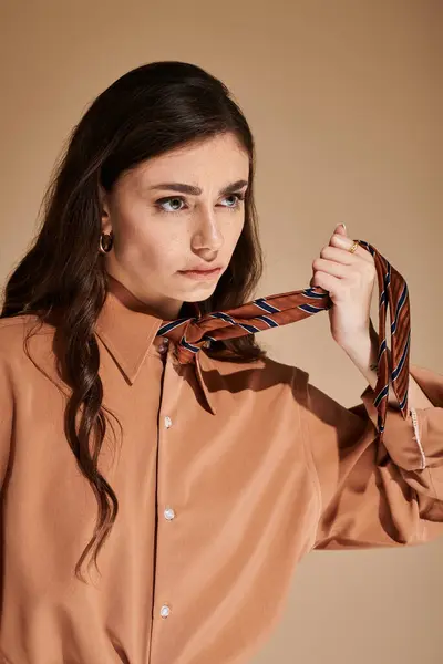 A young woman showcases her fashion sense in a stylish attire while posing elegantly in a studio. — Stock Photo